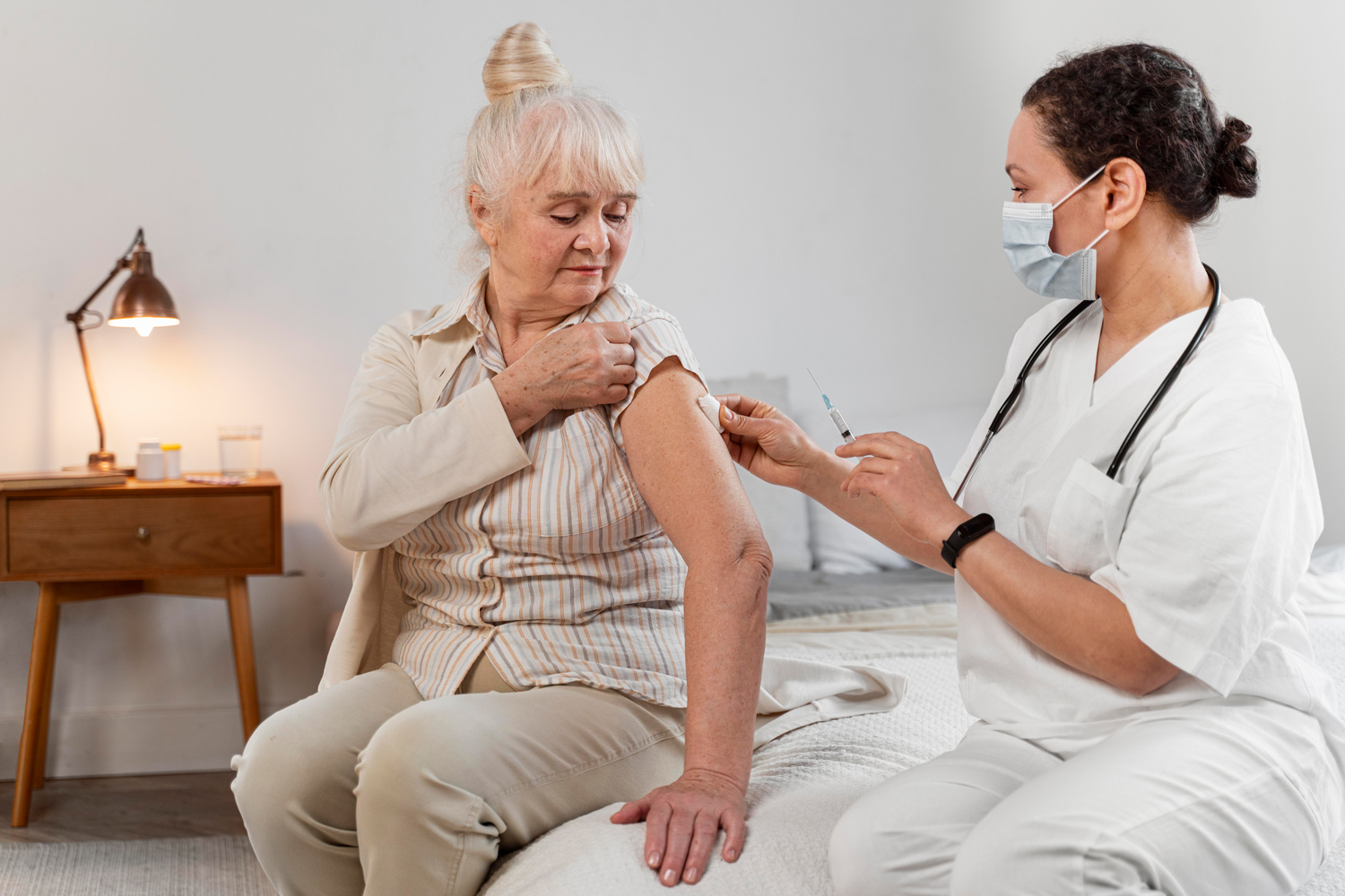doctor-preparing-vaccine-senior-woman