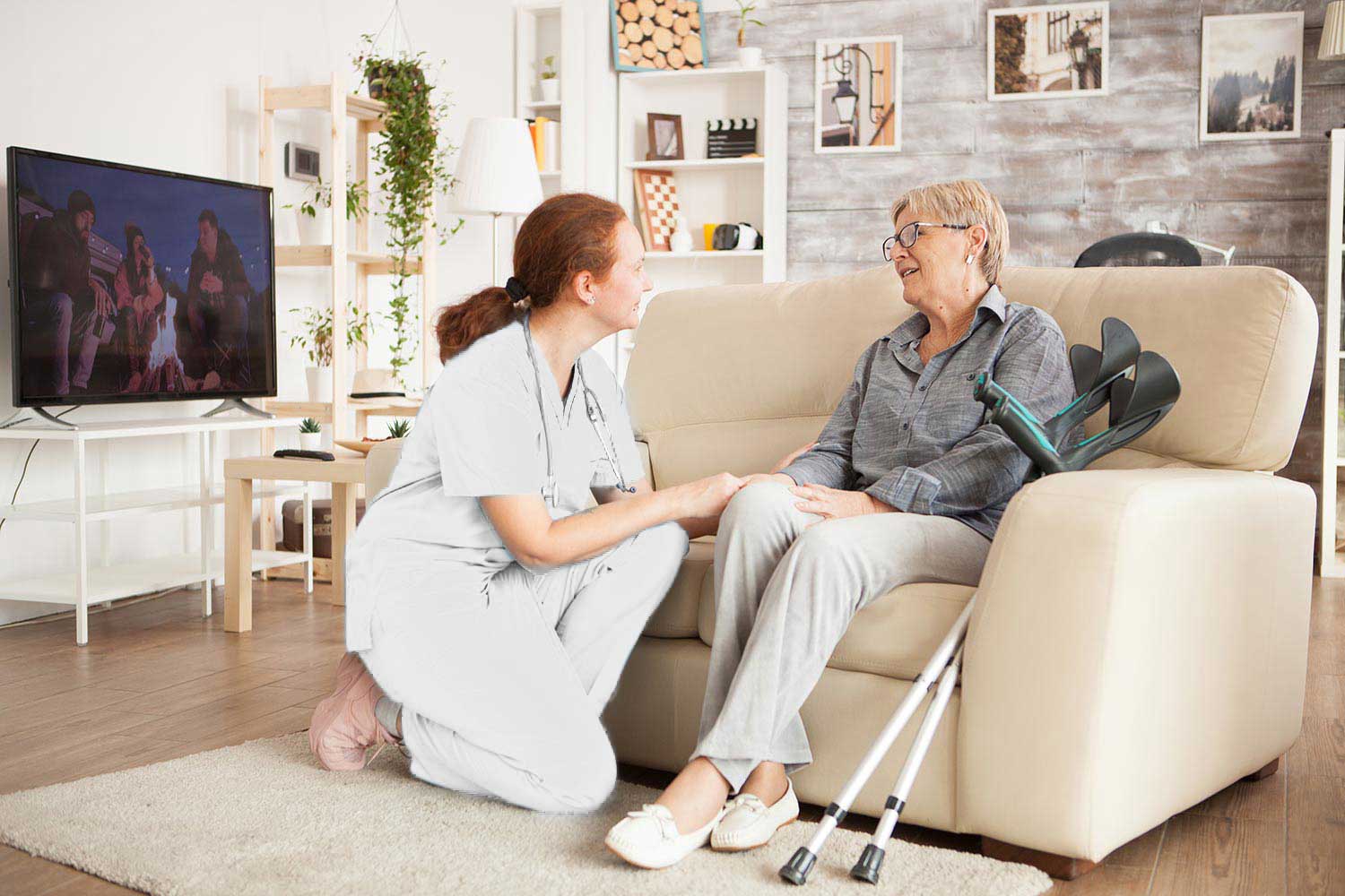young-female-nurse-wearing-white-uniform-talking-with-senior-woman-nursing-home