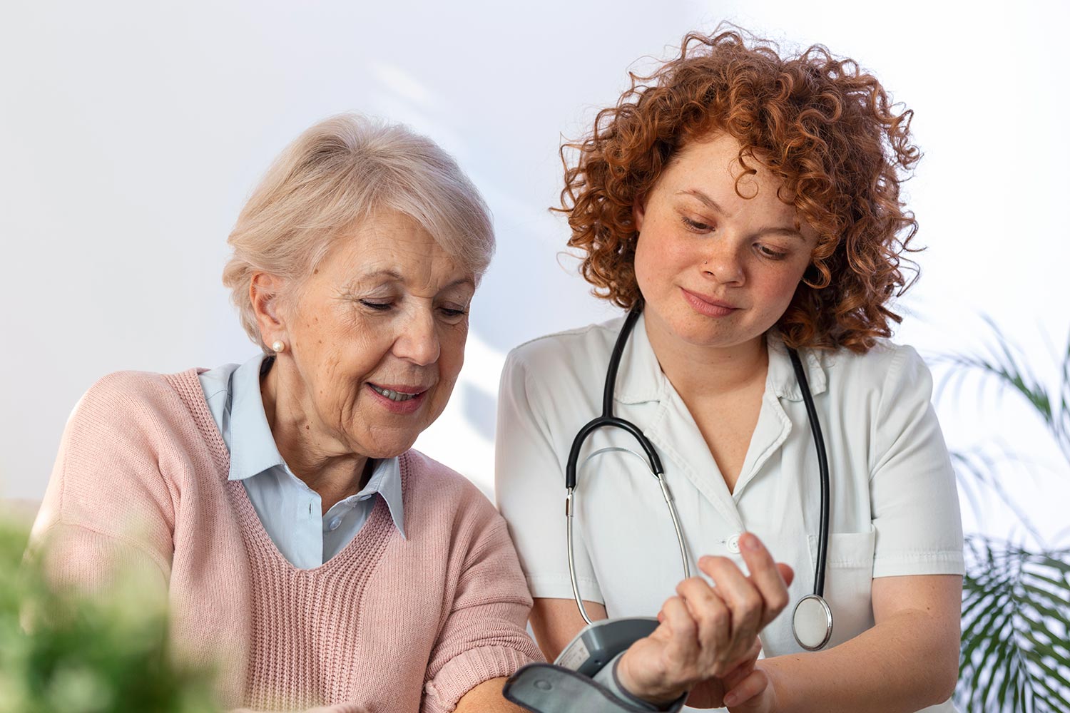 caregiver-measuring-blood-pressure-senior-woman-home-kind-carer-measuring-blood-pressure-happy-elderly-woman-bed-nursing-home